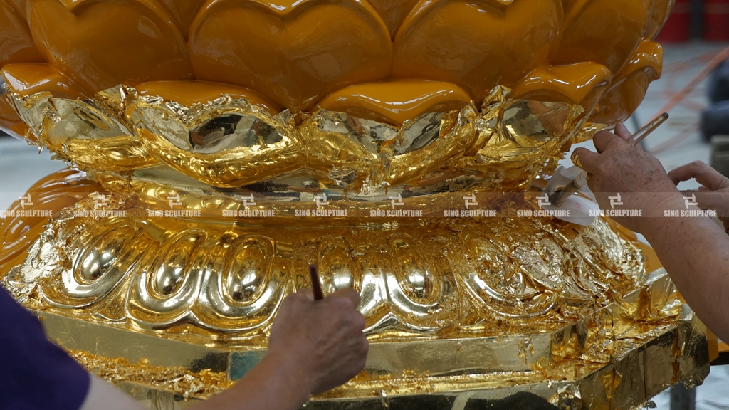 gold leaf process on Buddha statue